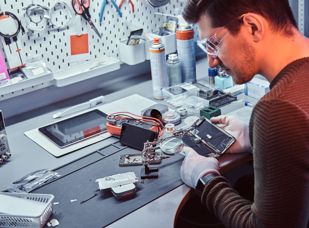 Phone technician repairing a phone