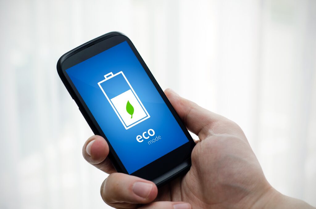 Man holding phone with eco battery mode on display