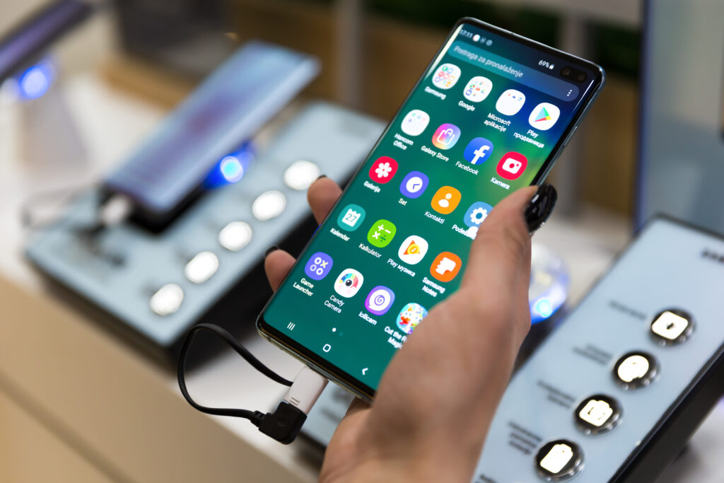 New Samsung S10 plus displayed in hand with apps on the screen